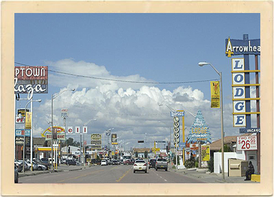 The “main drag” of Gallup, New Mexico, circa the 1980s. Notice the motel price of “two for $26.99” at the Arrowhead Lodge.