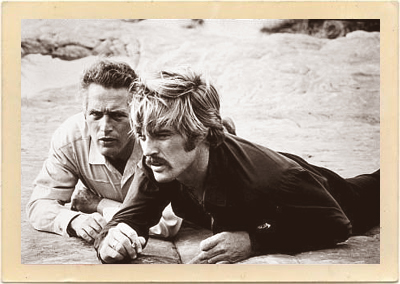 Butch (Paul Newman) and Sundance (Robert Redford) are on the watch for the super-posse who avidly pursues them in “Butch Cassidy and the Sundance Kid.”